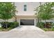 Spacious two-car garage with ample driveway, framed by green landscaping and a peek of home gym equipment at 4913 N Nebraska Ave # 5, Tampa, FL 33603