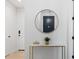 Entryway featuring a round mirror, a stylish table with a golden base, and neutral wall colors at 4913 N Nebraska Ave # 5, Tampa, FL 33603