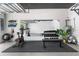 Home gym featuring a spin bike, yoga mats, weights, and a mirror at 4913 N Nebraska Ave # 5, Tampa, FL 33603