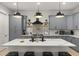 Modern kitchen with gray cabinets, stainless steel appliances, and a white marble island at 4913 N Nebraska Ave # 5, Tampa, FL 33603