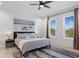Inviting bedroom featuring a comfortable queen-sized bed, large windows, and stylish decor at 4913 N Nebraska Ave # 5, Tampa, FL 33603