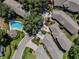 An aerial view of a residential area highlighting a home near a pool, landscaping, and driveway access at 5224 Fairway One Dr, Valrico, FL 33596