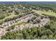 Aerial showing neighborhood, mature trees, and access to neighborhood pool at 5224 Fairway One Dr, Valrico, FL 33596