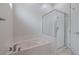 Bathroom area featuring a drop-in tub and a glass enclosed shower and tub at 5224 Fairway One Dr, Valrico, FL 33596