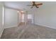 Expansive bedroom featuring plush carpet, neutral walls, and a modern ceiling fan at 5224 Fairway One Dr, Valrico, FL 33596