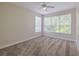Neutral carpeted bedroom with ceiling fan and natural light from two windows at 5224 Fairway One Dr, Valrico, FL 33596