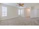 Spacious bedroom with plush carpet, ceiling fan, and abundant natural light at 5224 Fairway One Dr, Valrico, FL 33596