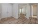 The stylish entryway featuring a double door entry, hardwood floors and view into the adjacent bedroom at 5224 Fairway One Dr, Valrico, FL 33596