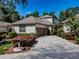 Charming home featuring a well-manicured lawn, a two-car garage, and neutral colored stucco siding at 5224 Fairway One Dr, Valrico, FL 33596