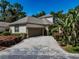 Charming home featuring a well-manicured lawn, a two-car garage, and neutral colored stucco siding at 5224 Fairway One Dr, Valrico, FL 33596