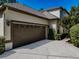 Two car garage with neutral colored door and stucco exterior, close up view at 5224 Fairway One Dr, Valrico, FL 33596