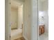 Hallway showcasing updated flooring, built-in storage, and access to the bathroom at 5224 Fairway One Dr, Valrico, FL 33596