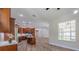 An open floor plan with a kitchen with wood cabinets and an island at 5224 Fairway One Dr, Valrico, FL 33596