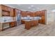 Spacious kitchen featuring cherry cabinets, marble countertops, stainless appliances, and wood flooring at 5224 Fairway One Dr, Valrico, FL 33596