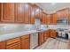 Features wood cabinets, stainless steel appliances, and light countertops at 5224 Fairway One Dr, Valrico, FL 33596