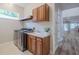 Laundry room featuring modern washer/dryer, sink, and overhead cabinetry at 5224 Fairway One Dr, Valrico, FL 33596
