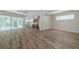 Open-concept living area featuring luxury vinyl flooring and neutral decor at 5224 Fairway One Dr, Valrico, FL 33596