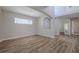 Spacious living room features hardwood floors, neutral paint, natural light, and modern lighting fixture at 5224 Fairway One Dr, Valrico, FL 33596