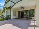 Screened patio with ceiling fan, providing a comfortable outdoor space adjacent to the home at 5224 Fairway One Dr, Valrico, FL 33596