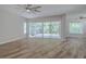A large living area with a screened-in patio and neutral walls at 5224 Fairway One Dr, Valrico, FL 33596