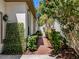 Charming side yard with greenery and brick pavers at 5224 Fairway One Dr, Valrico, FL 33596