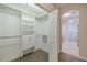 Well-organized walk-in closet with shelving and drawers, next to the bathroom at 5224 Fairway One Dr, Valrico, FL 33596