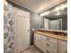 Bathroom features granite countertops, decorative mirror, and stylish wallpaper at 5258 Wisteria Cir, New Port Richey, FL 34653