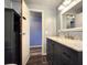 Bathroom featuring modern vanity, shower, and an additional cabinet for storage at 5258 Wisteria Cir, New Port Richey, FL 34653