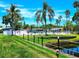 Beautiful community pool area surrounded by lush greenery, palm trees, and lounge chairs, perfect for relaxation and enjoyment at 5258 Wisteria Cir, New Port Richey, FL 34653
