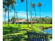 Beautiful community space with mature palm trees, a well-maintained lawn, and a charming community building at 5258 Wisteria Cir, New Port Richey, FL 34653