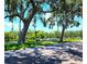 Scenic view of the community with mature trees and waterfront access to the boat docks at 5258 Wisteria Cir, New Port Richey, FL 34653