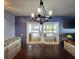 Dining area with a modern chandelier, a window and a view of the exterior at 5258 Wisteria Cir, New Port Richey, FL 34653