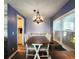 Charming dining area features a stylish light fixture and natural light streaming through the window at 5258 Wisteria Cir, New Port Richey, FL 34653