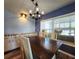 The dining area features custom cabinets, a modern light fixture and chairs that surround a wood table at 5258 Wisteria Cir, New Port Richey, FL 34653