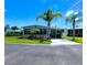 Exterior of a light blue home, lush landscaping, with two palm trees in the front yard at 5258 Wisteria Cir, New Port Richey, FL 34653