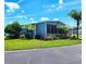 Inviting single-story home featuring a well-maintained lawn, mature trees, and beautiful landscaping at 5258 Wisteria Cir, New Port Richey, FL 34653