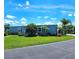 Charming single-story home with a well-manicured lawn, lush trees, and a welcoming curb appeal at 5258 Wisteria Cir, New Port Richey, FL 34653