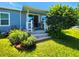 Charming home exterior with landscaped garden beds and a cozy porch at 5258 Wisteria Cir, New Port Richey, FL 34653