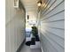 The side of the home is shown with a walkway leading to a cozy seating area on the covered porch at 5258 Wisteria Cir, New Port Richey, FL 34653