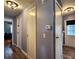 Hallway with three doors and updated flooring and lighting at 5258 Wisteria Cir, New Port Richey, FL 34653