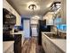 Well-lit kitchen featuring white cabinets, black appliances, and modern countertops at 5258 Wisteria Cir, New Port Richey, FL 34653