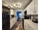 Updated kitchen features modern appliances, white cabinetry, stylish hardware, and luxury vinyl plank flooring at 5258 Wisteria Cir, New Port Richey, FL 34653
