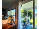 Comfortable outdoor patio with white sheer curtains and views of lush greenery at 5258 Wisteria Cir, New Port Richey, FL 34653