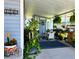Cozy covered porch with comfortable seating, plants, and welcoming decor at 5258 Wisteria Cir, New Port Richey, FL 34653