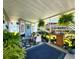 Covered porch with plants and seating at 5258 Wisteria Cir, New Port Richey, FL 34653