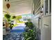 Inviting covered porch with ferns and lots of plants at 5258 Wisteria Cir, New Port Richey, FL 34653