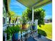 Inviting porch view showcasing vibrant plants and a lush green yard at 5258 Wisteria Cir, New Port Richey, FL 34653