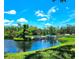 Beautiful waterfront view of the community boat docks with lush greenery and blue skies at 5258 Wisteria Cir, New Port Richey, FL 34653