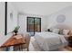 Bright bedroom with desk area, white bedding, and sliding glass doors to the outside at 532 W Plaza Pl # 3, Tampa, FL 33602