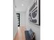 Hallway with hardwood floors, gray walls, a modern bench, and modern art at 532 W Plaza Pl # 3, Tampa, FL 33602